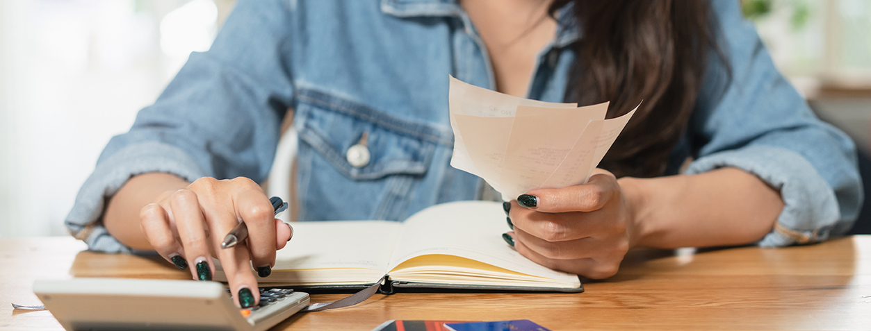 Woman doing accounting home finance expenses and calculate credit card bill.